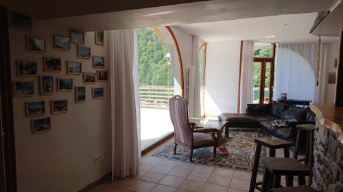 a living room with a couch and a table at Superbe logement 12 pers famille ou groupe. in Laruns