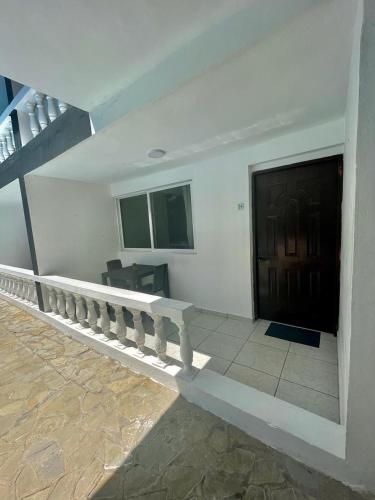 a white building with a staircase and a door at HUMMINGBIRD CABARETE in Cabarete