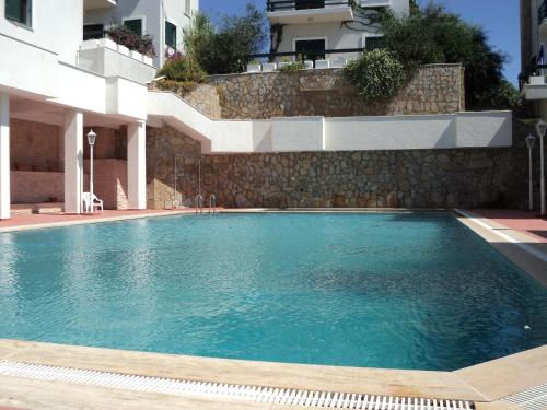 a swimming pool in front of a building at PLEASENT SUNSET in CESME-SITE SOLEY 17 in Cesme