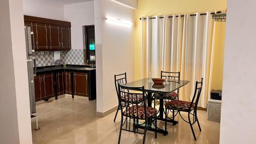 a dining room table and chairs in a kitchen at Pebbles 2BHK Home By Goaround Homes in Siolim