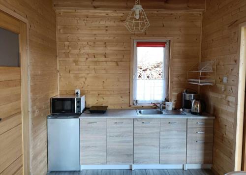 a kitchen with a sink and a microwave at Domek u Natalii 