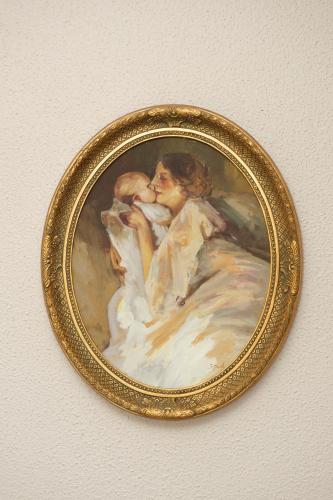 a painting of a woman with a baby on a wall at Greenfield Lodge Hotel Bar & Bistro in Headford