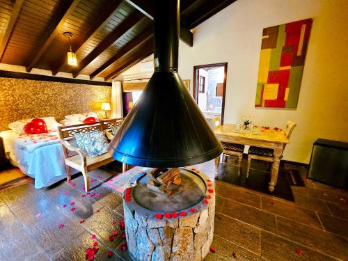 a living room with a fireplace in the middle of a room at Estalagem Wiesbaden in Monte Verde