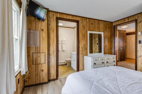 a bedroom with a white bed and a bathroom at The Inn at Lewes in Rehoboth Beach