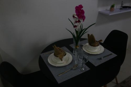 a table with plates and hats on top of it at Triann Condo Staycation Davao in Inspiria Condominium Building in Davao City
