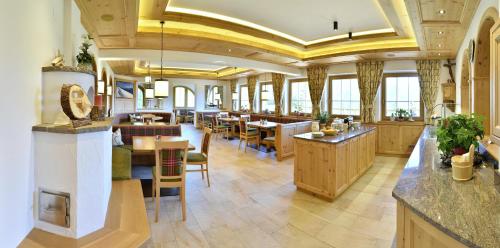 a restaurant with tables and chairs in a room at Alpenkönig in Zell am Ziller