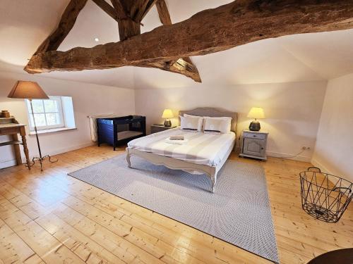 a large bedroom with a bed and a piano at La spacieuse maison des miots in Hiersac