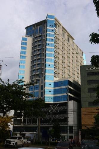 a large blue building with a sign on it at Triann Condo Staycation Davao in Inspiria Condominium Building in Davao City