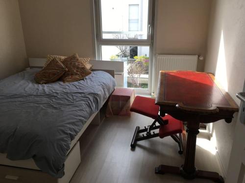 une chambre avec un lit, un bureau et une chaise dans l'établissement Appartement centre-ville, à Annecy