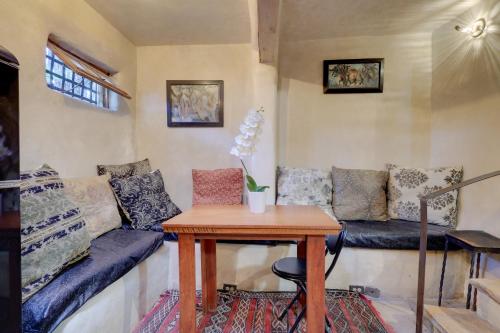 a living room with a couch and a table at Adobe Studio 2 Blocks to Dtwn Santa Fe Plaza! in Santa Fe