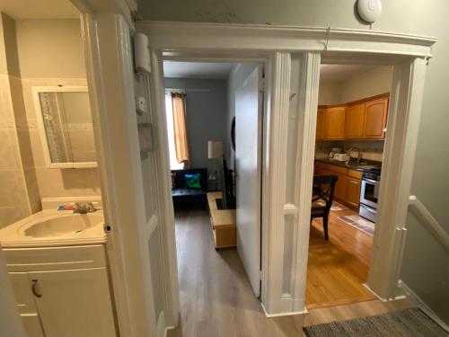 a hallway leading to a kitchen with a sink at Enjoyapt Patio, Ready4all Kind The Whether in West New York