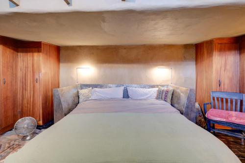 a bedroom with a large bed and a chair at Adobe Studio 2 Blocks to Dtwn Santa Fe Plaza! in Santa Fe