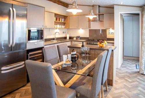 a kitchen with a table and chairs and a refrigerator at Stewarts Resort Lodge 16 in St Andrews