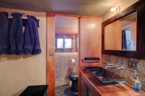 a bathroom with a sink and a toilet and a mirror at Studio 2 Blocks From Downtown Santa Fe Plaza! in Santa Fe