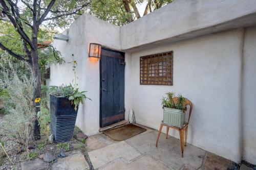 a house with a blue door and a chair at Adobe Studio 2 Blocks to Dtwn Santa Fe Plaza! in Santa Fe