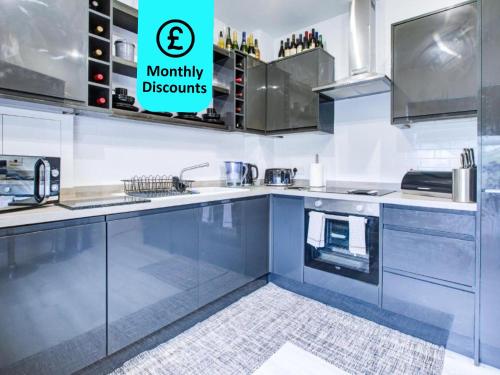 a kitchen with stainless steel appliances and a sign that says mummy discounts at Modern 2-Bedroom - 2 Bathroom Apartment in Waltham Abbey-Gated Car Park-Fast Internet in Waltham Abbey