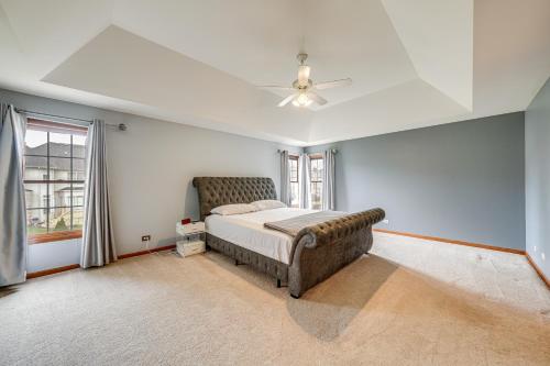 a bedroom with a bed and a ceiling fan at In-Home Theater Modern Naperville Vacation Rental in Naperville