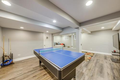 a room with a ping pong table in it at In-Home Theater Modern Naperville Vacation Rental in Naperville