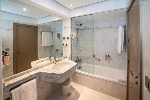 a bathroom with a sink and a shower at Mercure Monte Igueldo in Donostia-San Sebastián