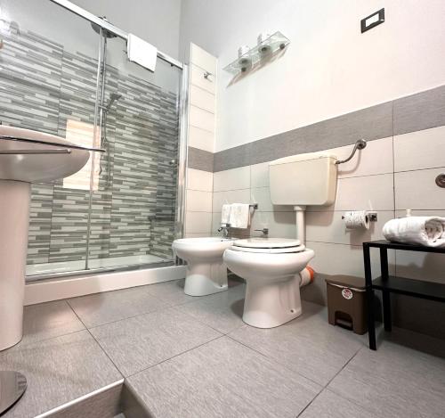 a bathroom with a toilet and a sink and a shower at Calvino Home in Trapani