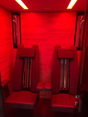 a group of red chairs in a red room at Appartements Wolf in Leutasch