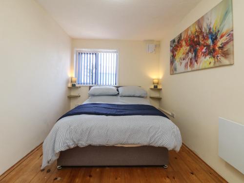 a bedroom with a bed with two pillows on it at Flat 1 Marina Court in Redruth