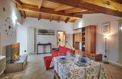 a living room with a red couch and a table at Twins attic in the center in Lierna