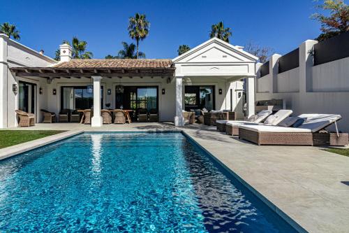 ein Pool vor einem Haus in der Unterkunft Villa Casiopea- Stunning holiday villa in Marbella in Marbella