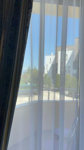 a window with a view of a building at Rritja e Koranit in Pogradec
