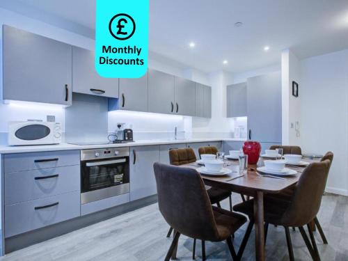 a kitchen with a table and chairs in a kitchen at 2 bed 2 bath Modern Apartment in East Acton in London