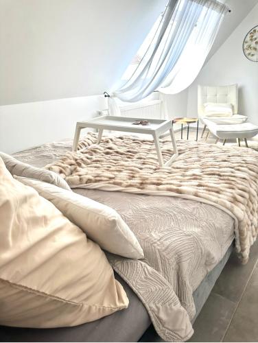 a bedroom with a bed with a table on it at Deluxe Apartment in Duisburg
