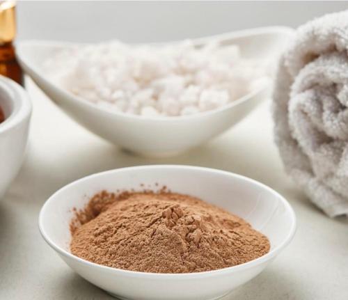 a bowl of cocoa next to other bowls of flour at Maison d'Hôtes & Savonnerie de Bonnefon in Saint-Chély-dʼAubrac