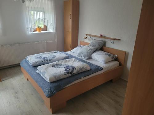 a bed with two pillows on it in a room at Apartma Vida in Videm pri Ptuju