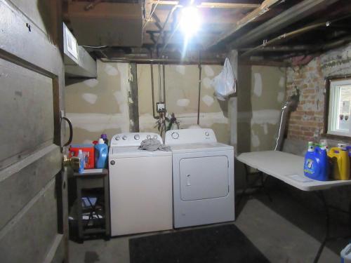 a kitchen with a washing machine and a sink at Red Robin Rentals - Wicker Park in Chicago