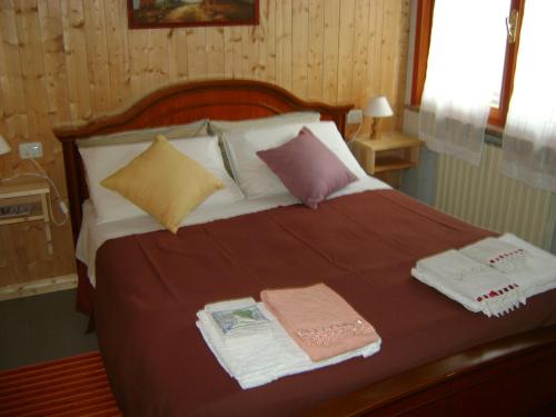 a bed with two towels and pillows on it at B&B Lattemiele in Fontanellato