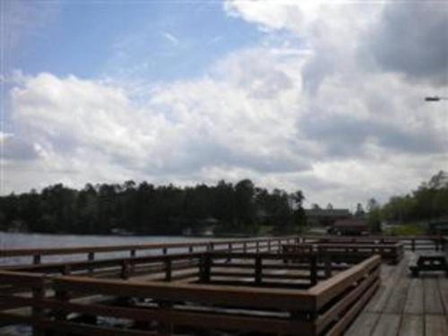 a wooden fence next to a body of water at Minocqua Lake Condo B7 in Minocqua
