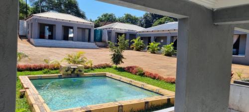a house with a swimming pool in the yard at Lugogo Guesthouse in Thohoyandou