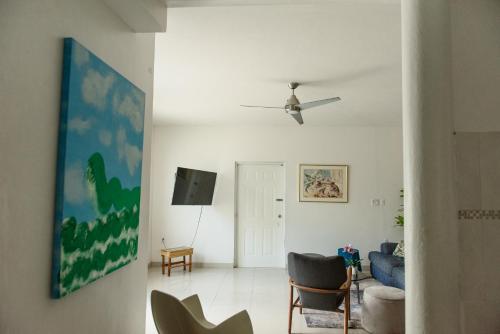 a living room with a couch and a ceiling fan at Casa Magdalena in San Juan