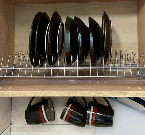 a shelf with a bunch of plates and utensils at Апарт-СЕРВiC жк Сонячний квартал in Solochin