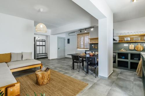 a living room with a couch and a table at Casa Naturale in Skopelos Town