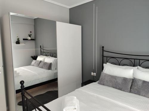a bedroom with two beds and a mirror at Amalia's Luxury Apartment in Thessaloniki