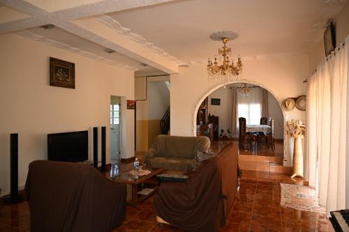 a living room with a couch and a tv at Résidence Tianay in Antananarivo