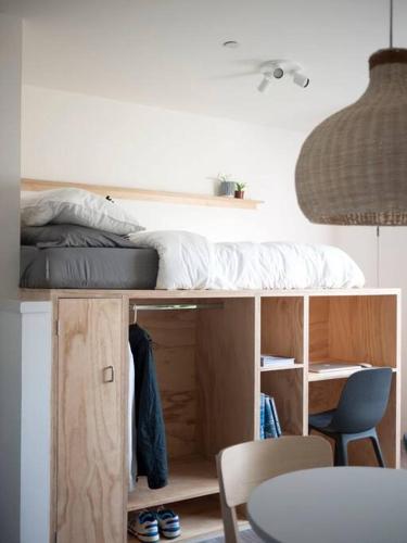 a bedroom with a bed and a table and chairs at Contemporary City Studio Apartment 2 Minutes from Station in Aberdeen