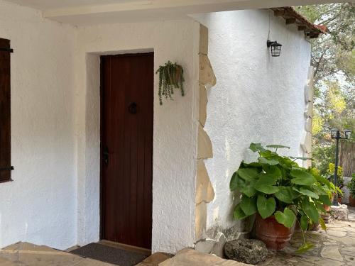 a door to a house with a potted plant at TERRAVU in Sant Pere de Ribes
