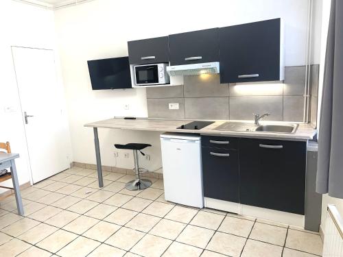 a kitchen with a sink and a counter top at locationbonappart1 in Limoges