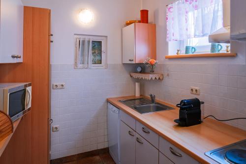 a small kitchen with a sink and a counter at Ferienhaus Marienkeller in Leibnitz