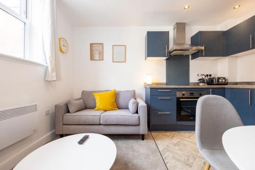 a living room with a couch and a kitchen at Apartment For Two Near Bolton Train Station in Bolton
