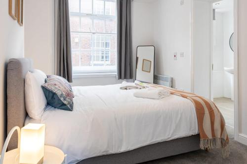 a bedroom with a large bed with a mirror at Apartment For Two Near Bolton Train Station in Bolton
