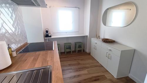 a bathroom with a sink and a mirror at Puerto Placilla in El Puerto de Santa María