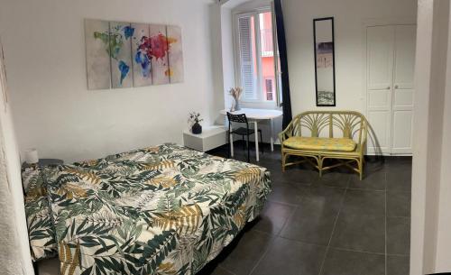 a bedroom with a bed and a table and a chair at [ Hébergement partagé à proximité de la place du marché à Bastia ] in Bastia